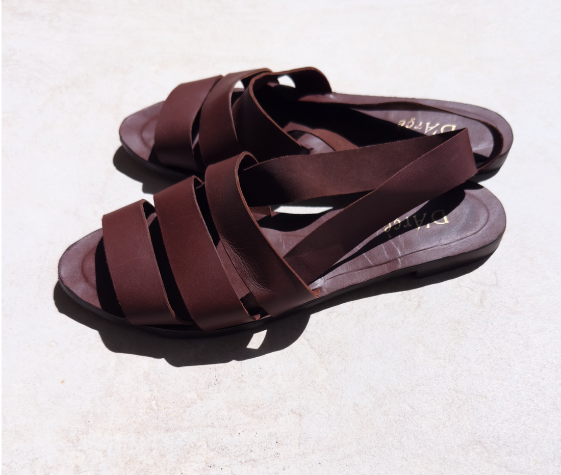 The Gramercy leather sandals with three straps across the foot and a slingback in chocolate brown. 